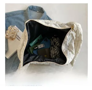 Detailed internal view showing large capacity of white quilted puffer tote bag