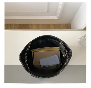 Top view of spacious interior of black crocodile pattern tote bag with gold chain
