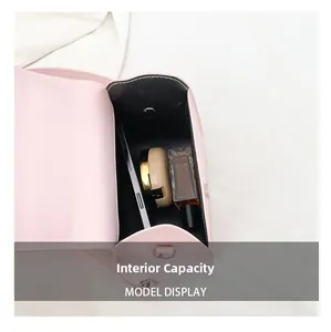 Interior capacity of pink crossbody bag showing space for phone, perfume and makeup