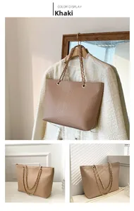 Detail view of khaki embossed leather tote bag with elegant gold chain strap
