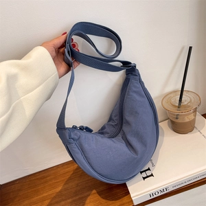 Minimalist navy nylon crescent crossbody bag with adjustable strap for urban casual style