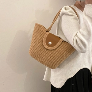 French style straw woven tote bag with brown leather flap and large pearl accent
