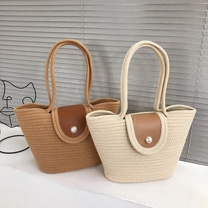 Woven basket bucket bags in brown and white with leather lid and pearl decoration