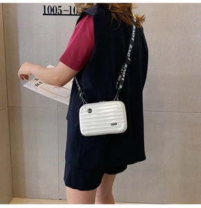 Detail of white mini suitcase crossbody bag with LOVE printed wide fabric shoulder strap