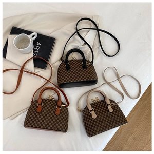 Detailed overhead view of mini shell-shaped crossbody bags with vintage geometric patterns