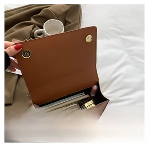 Internal view of the brown flap crossbody bag showing storage capacity for daily essentials