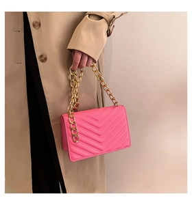 Hot pink shoulder bag featuring chevron stitching and a chunky gold chain detail