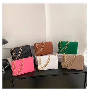 Various colors of quilted crossbody bags with chunky gold chains shown in a row