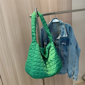 Large green quilted puffer shoulder bag made of space cotton with wide strap