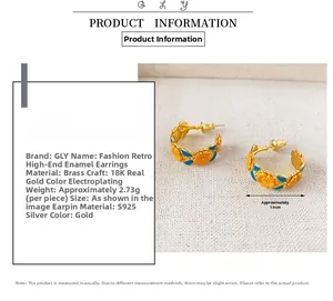 Macro view of gold-plated enamel camellia earrings with 1.9cm diameter measurement