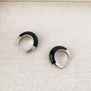 Minimalist thick silver hoop earrings with black enamel inlay in a modern style