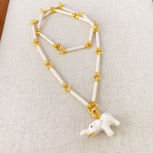 Summer enamel elephant necklace with white bamboo links and golden metal accents