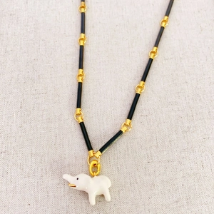 Bamboo chain necklace featuring a white enamel elephant pendant with gold accents