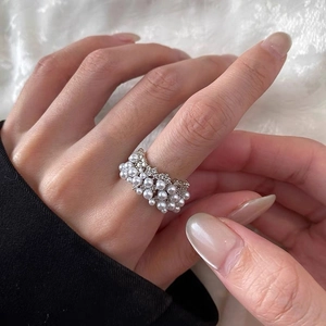 Elegant wide pearl ring with sparkling cubic zirconia on a luxury faux fur background
