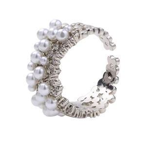 Elegant adjustable ring with rows of faux pearls and sparkling crystals on silver band