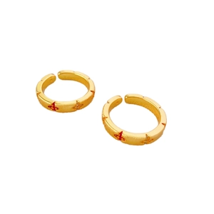 Adjustable brushed gold four-leaf clover rings set with red sparkling accents