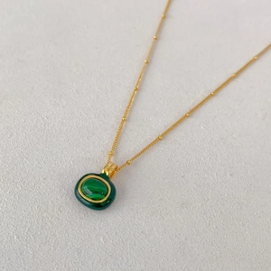 Nahaufnahme der Goldkette mit Malachit-Anhänger und grünem Emaille-Rand-Inlay