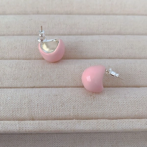 Chic pink enamel puff stud earrings with 925 silver needles on a jewelry display tray
