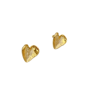 Fashionable golden hammered heart stud earrings with minimalist metal texture on white background