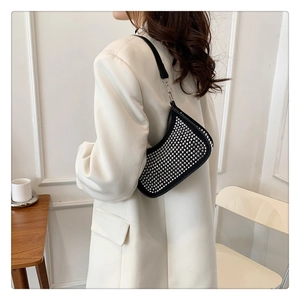 Detail of black rhinestone hobo bag on model in beige blazer for daily outfit inspiration