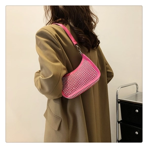 Chic pink rhinestone crescent hobo bag shown on a beige blazer for trendy styling
