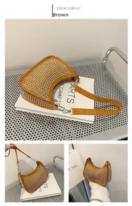 Detail of brown hobo bag with silver rivets and smooth metallic zipper closure