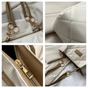 Detailed close-up of cream quilted tote bag showing golden hardware and strap stitching