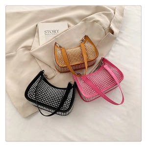Flat lay of colorful leather crescent bags with silver dome rivets in black pink and yellow