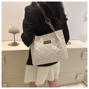 Quilted tote bag detail showing the beige PU leather texture and Fashion brand label