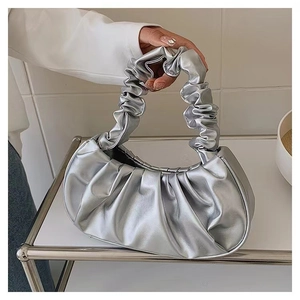 Metallic silver ruched cloud handbag with pleated handle and minimalist fashion design