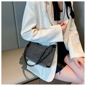 Fashionable rhinestone shoulder bag with sparkling silver crystals on black leather