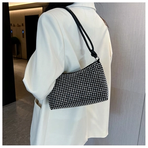 Close-up of black rhinestone shoulder bag with crystal embellishments and knotted strap