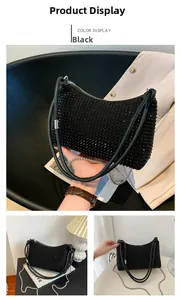 Close-up of black rhinestone shoulder bag with metal chain strap and luxury zipper detail