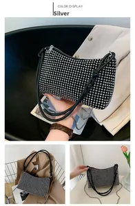 Detailed close-up of sparkling silver rhinestone handbag with elegant metal chain strap