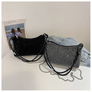 Detailed view of rhinestone shoulder bags in black and silver with stylish metal chains