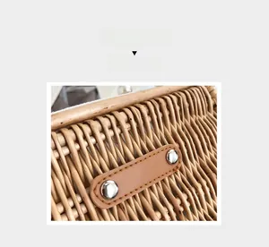 Close-up of hand-woven wicker bag showing leather patch detail and silver rivets