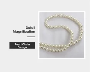 Detail magnification of the elegant round pearl chain strap on the straw woven handbag