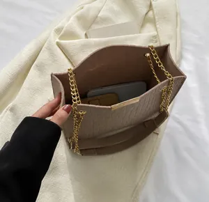 Top view of beige crocodile embossed tote bag interior showing phone and wallet storage