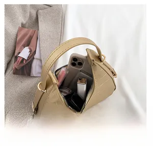 Interior view showing the storage capacity of khaki crocodile-patterned crescent bag