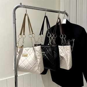 Quilted diamond lattice tote bag in cream, black and white with gold chain straps