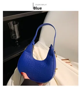 Detailed view of blue crocodile pattern hobo bag with premium gold zipper hardware