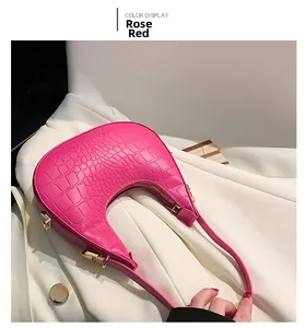 Detail of rose red crocodile pattern crescent bag with premium gold metal zippers