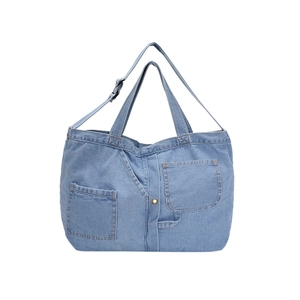 Light blue denim canvas tote bag with front pockets and adjustable shoulder strap