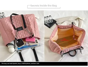 Macro view of the large capacity main pocket of a pink quilted nylon tote bag with inner space