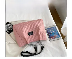 Overhead view of pink quilted nylon tote bag showing chain strap and spacious interior