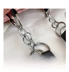 Close-up of premium silver metal buckle and black leather strap on a pink tote bag