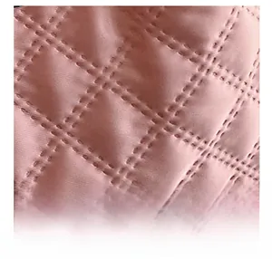 Close-up of pink quilted nylon fabric with precise diamond stitching on tote bag