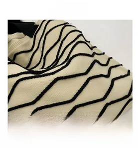 Close-up of the vintage knitted tote bag showing black wavy texture and cream fabric