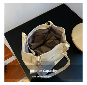 Detailed view of the large capacity interior with dark fabric lining and zip pocket