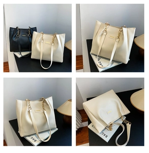 Detail view of large tote bags with pebble grain texture and metal chain strap in two colors
